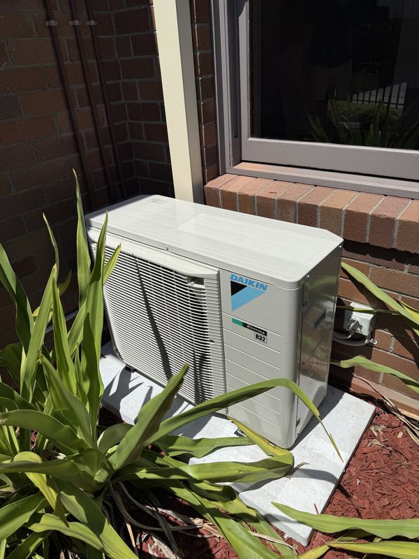 Daikin inverter outdoor unit on a concrete pad, with weatherproof isolator, Double Bay, NSW